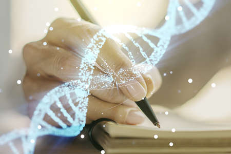 Creative light DNA illustration and woman hand writing in diary on background, science and biology concept. Multiexposureの写真素材