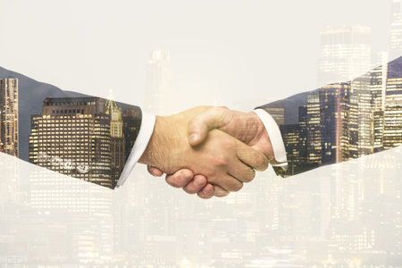 Multi exposure of handshake two businessmen on cityscape background, deal and partnership concept