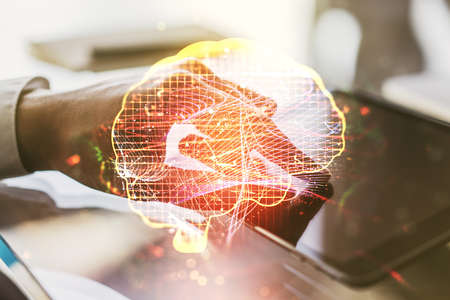 Double exposure of creative human brain microcircuit and hand working with a digital tablet on background. Future technology and AI conceptの写真素材