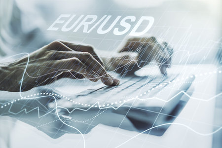 Creative EURO USD financial graph illustration and hands typing on computer keyboard on background,...