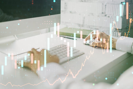 Multi exposure of abstract creative financial chart with hand typing on computer keyboard on...