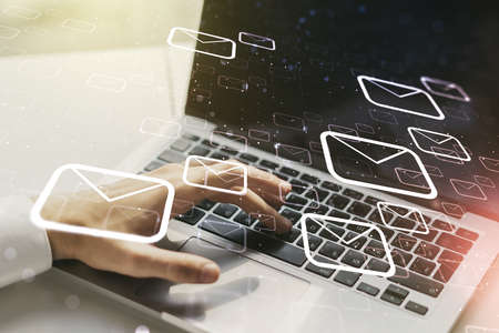 Creative abstract postal envelopes sketch with hands typing on computer keyboard on background, e-mail and marketing concept. Double exposureの写真素材