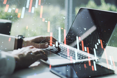 Creative concept of crisis chart illustration with hands typing on laptop on background. Global...