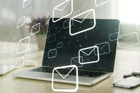Creative abstract postal envelopes sketch on modern laptop background, e-mail and marketing concept. Double exposureの写真素材