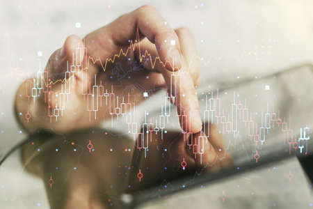Multi exposure of abstract creative financial chart with finger presses on a digital tablet on background, research and analytics conceptの写真素材
