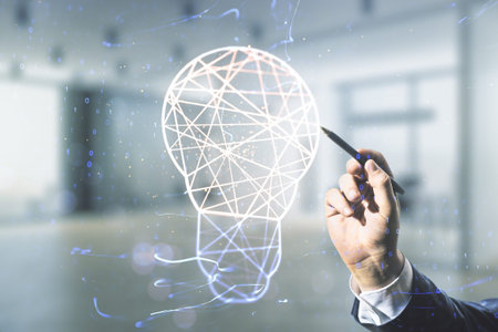 Double exposure of male hand with pen draws creative light bulb hologram on blurred office...