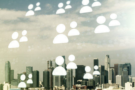 Double exposure of abstract virtual social network icons on Los Angeles city skyscrapers background....