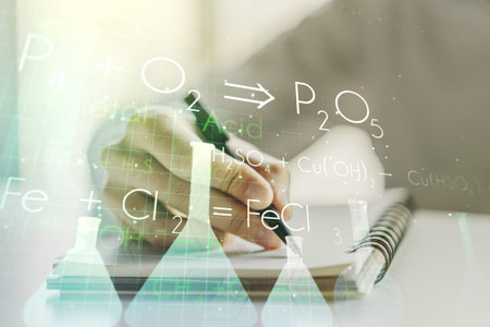 Creative chemistry illustration with man hand writing in diary on background, science and research...