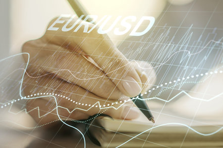 Double exposure of creative EURO USD forex chart hologram and woman hand writing in notebook on...