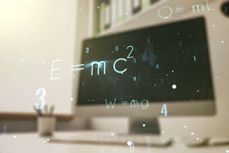 Creative scientific formula hologram and modern desk with computer on background, research concept. Multiexposureの写真素材