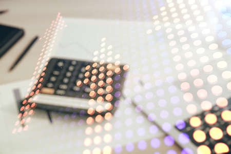 Virtual upward arrows hologram on blurry calculator and computer background, leadership and motivation concept. Multiexposureの写真素材