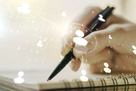 Double exposure of social network icons concept with man hand writing in notebook on background. Marketing and promotion conceptの写真素材