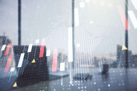 Abstract creative financial graph with world map and modern desktop with pc on background, financial and trading concept. Multiexposureの写真素材