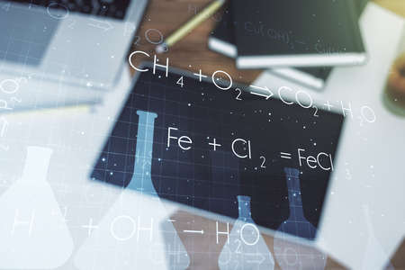 Creative chemistry concept and modern digital tablet on background, top view. Multiexposureの写真素材