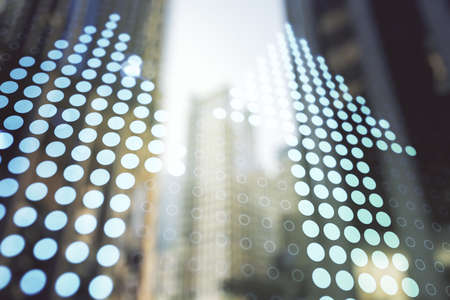 Virtual upward arrows illustration on office buildings background. Breakthrough and progress concept. Multiexposureの写真素材