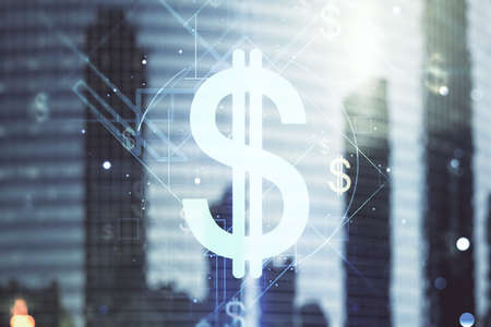 Double exposure of virtual USD symbols hologram on modern skyscrapers background. Banking and investing conceptの写真素材