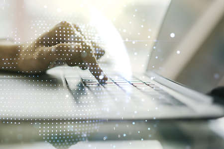 Double exposure of abstract digital world map and hand typing on laptop on background, big data and blockchain conceptの写真素材