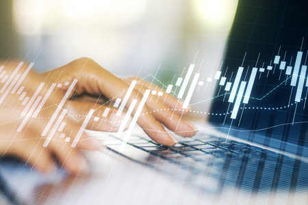 Double exposure of abstract creative financial chart with hand typing on computer keyboard on background, research and strategy conceptの写真素材