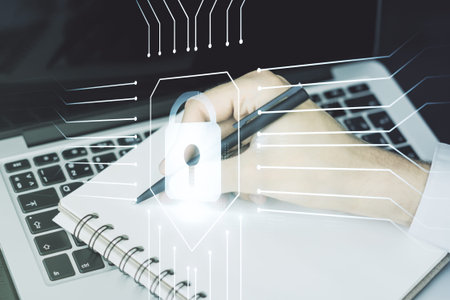 Creative lock sketch with chip hologram and hand writing in notepad on background with laptop,...
