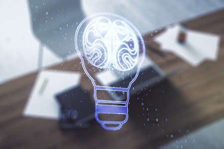 Creative light bulb illustration with human brain and modern desktop with pc on background, future technology concept. Multiexposureの写真素材