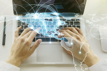 Double exposure of abstract digital world map with connections and hand typing on computer keyboard...