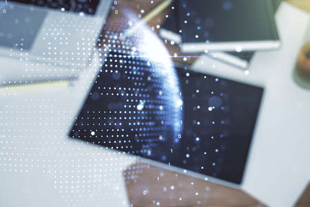 Multi exposure of abstract graphic world map and modern digital tablet on desktop on background, top view, big data and networking conceptの写真素材