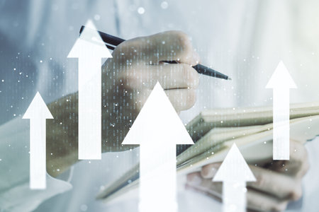 Creative abstract upward arrows sketch and man hand writing in notepad on background, target and...