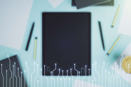 Creative abstract micro chip hologram and modern digital tablet on desktop on background, top view, artificial intelligence and machine learning concept. Multi exposureの写真素材