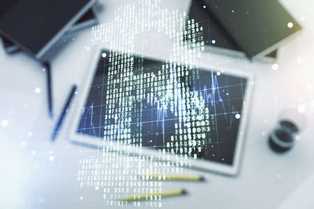 Double exposure of creative Bitcoin symbol and digital tablet on background, top view. Cryptocurrency conceptの写真素材