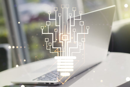 Creative idea concept with light bulb and microcircuit illustration on modern laptop background....