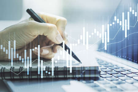Multi exposure of abstract financial graph with hand writing in notebook on background, financial and trading conceptの写真素材