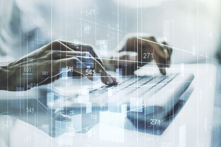 Double exposure of abstract creative statistics data hologram with hands typing on laptop on...
