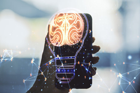 Double exposure of creative light bulb hologram with human brain and hand with cell phone on...