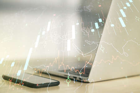 Multi exposure of abstract creative financial chart with world map on laptop background, research and analytics conceptの写真素材