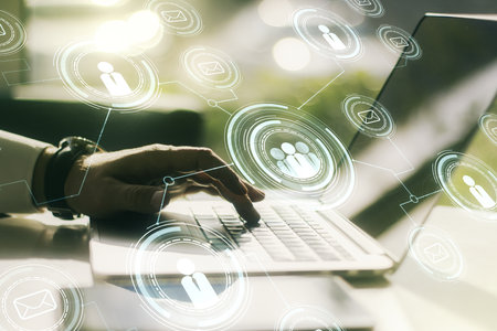 Double exposure of social network icons concept with hand typing on computer keyboard on background. Networking conceptの写真素材