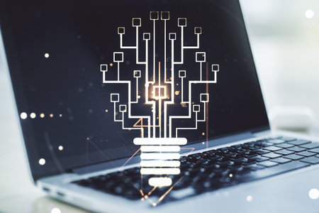 Creative light bulb with chip hologram on modern laptop background, artificial Intelligence and...