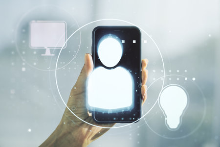 Double exposure of social network icons concept and hand with cellphone on background. Networking conceptの写真素材