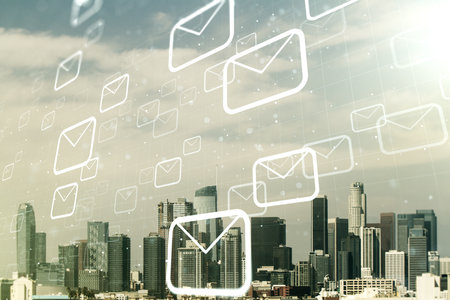 Double exposure of abstract virtual postal envelopes hologram on Los Angeles city skyscrapers background. Electronic mail and spam conceptの写真素材