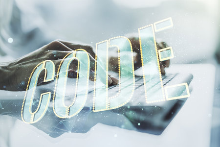 Creative Code word sign and hands typing on laptop on background, international software development concept. Multiexposureの写真素材