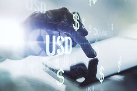 Double exposure of creative USD symbols hologram and finger clicks on a digital tablet on background. Banking and investing conceptの写真素材