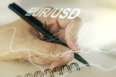 Creative EURO USD forex graph sketch and man hand writing in notepad on background, strategy and forecast concept. Multiexposureの写真素材