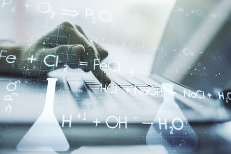 Double exposure of creative chemistry concept with hands typing on laptop on background, research...