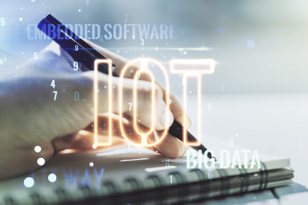 Creative IOT concept with woman hand writing in notebook on background. Multiexposureの写真素材