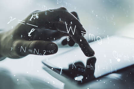 Creative scientific formula concept with finger clicks on a digital tablet on background. Multiexposureの写真素材