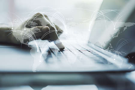 Double exposure of abstract digital world map with connections and hands typing on laptop on background, research and strategy conceptの写真素材