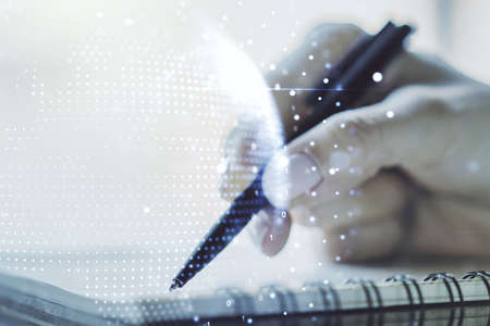Abstract creative digital world map and woman hand writing in diary on background, globalization concept. Multiexposureの写真素材