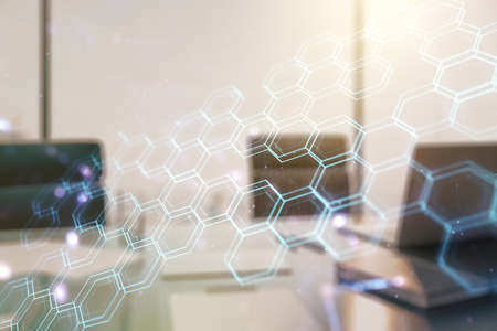 Creative concept of wireless technology with hexagon hologram and modern desktop with computer on background. Big data and database concept. Multiexposureの写真素材