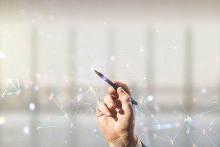 Man hand with pen draws abstract virtual wireless technology hologram on blurred office background,...