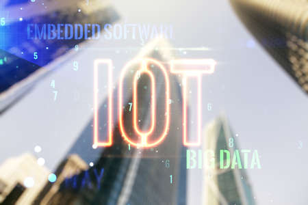 Double exposure of abstract virtual IOT hologram on modern skyscrapers background, research and development conceptの写真素材