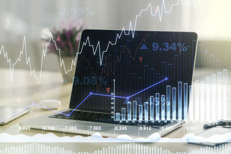 Multi exposure of abstract financial graph on laptop background, financial and trading conceptの写真素材